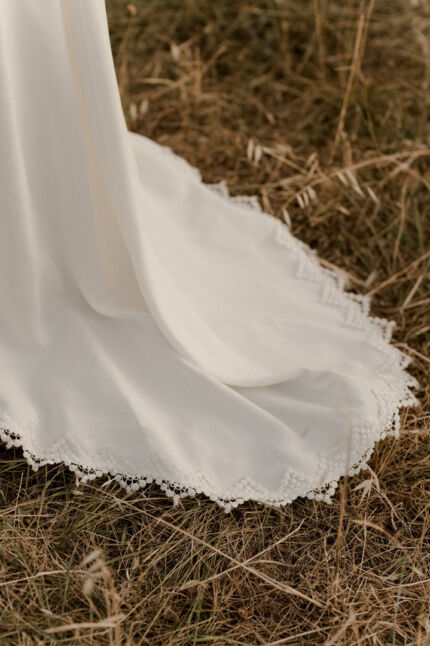 LA ROBE LOOKER est une robe de mariée moderne très chic. En crêpe fluide et guipure écoresponsable, ses manches rehaussées, sa taille transparente et son grand décolleté dans le dos apportent force et originalité pour une mariée affirmée. Bijoux LA ROBE LOOKER