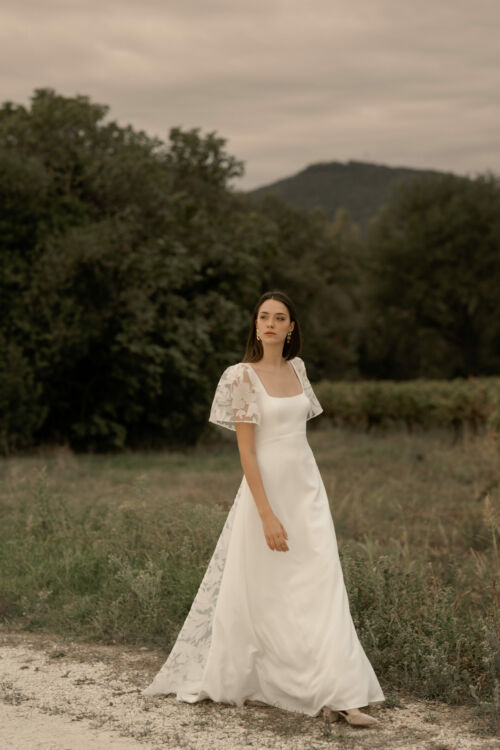 NORA est une robe de mariée moderne en crêpe eco-friendly et en organza fils coupés. La traine est amovible et les manches sauront se moquer d'une belle poitrine.
