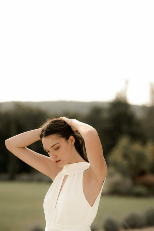 NUNCIA est une robe de mariée moderne et chic. L'élégance du col charmera celles qui ne veulent pas de décolleté.