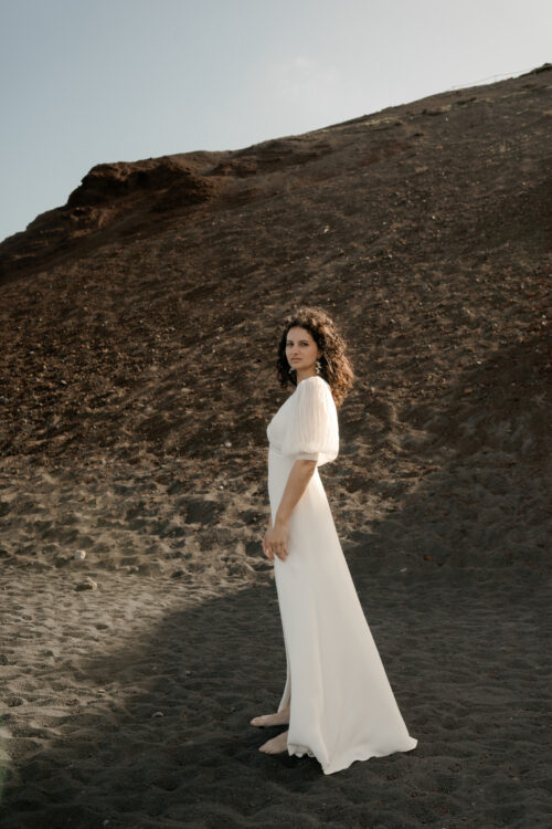 PODEROSA est une robe de mariée moderne. Ses manches bouffantes et sa taille transparente sont en mousseline plissée. Bijoux @anthemis.paris
