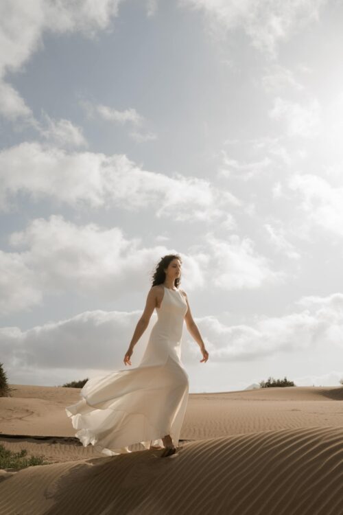 PARADISE est une robe de mariée chic en crêpe de soie. Son décolleté « emmanchures américaines » et son dos habillé de bretelles en font une robe de mariée minimaliste élégante. La jupe est incrustée de mousseline de soie pour faire une robe de mariée fluide. Bijoux @anthemis.paris