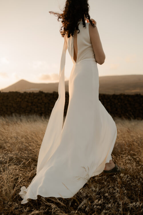 ONDINE est une robe de mariée chic en crêpe de soie. Son décolleté asymétrique en fait une robe de mariée élégante. C’est une robe de mariée drapée féminine pour un mariage cool et chic. Bijoux @anthemis.paris