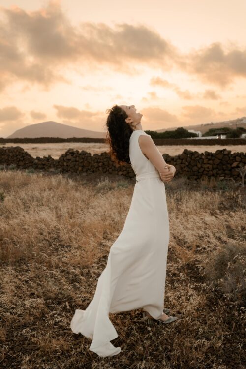 PERFECTUM est une robe de mariée chic. Le col et la ceinture sont en crêpe de soie drapé avec délicatesse. Cette robe de mariée minimaliste conviendra parfaitement pour un mariage cool et chic. Bijoux @anthemis.paris. Chaussures @flordeasoka_paris