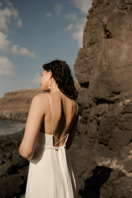 PLAISIR est une robe de mariée féminine en crêpe de soie. Son décolleté fines bretelles en fait une robe de mariée sensuelle. Sa jupe incrustée de quilles en mousseline de soie donnera une allure incroyable pour un mariage cool et chic. Bijoux @anthemis.paris